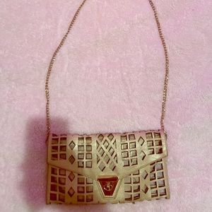 A cream/ tan clutch, hand bag, crossbody purse
